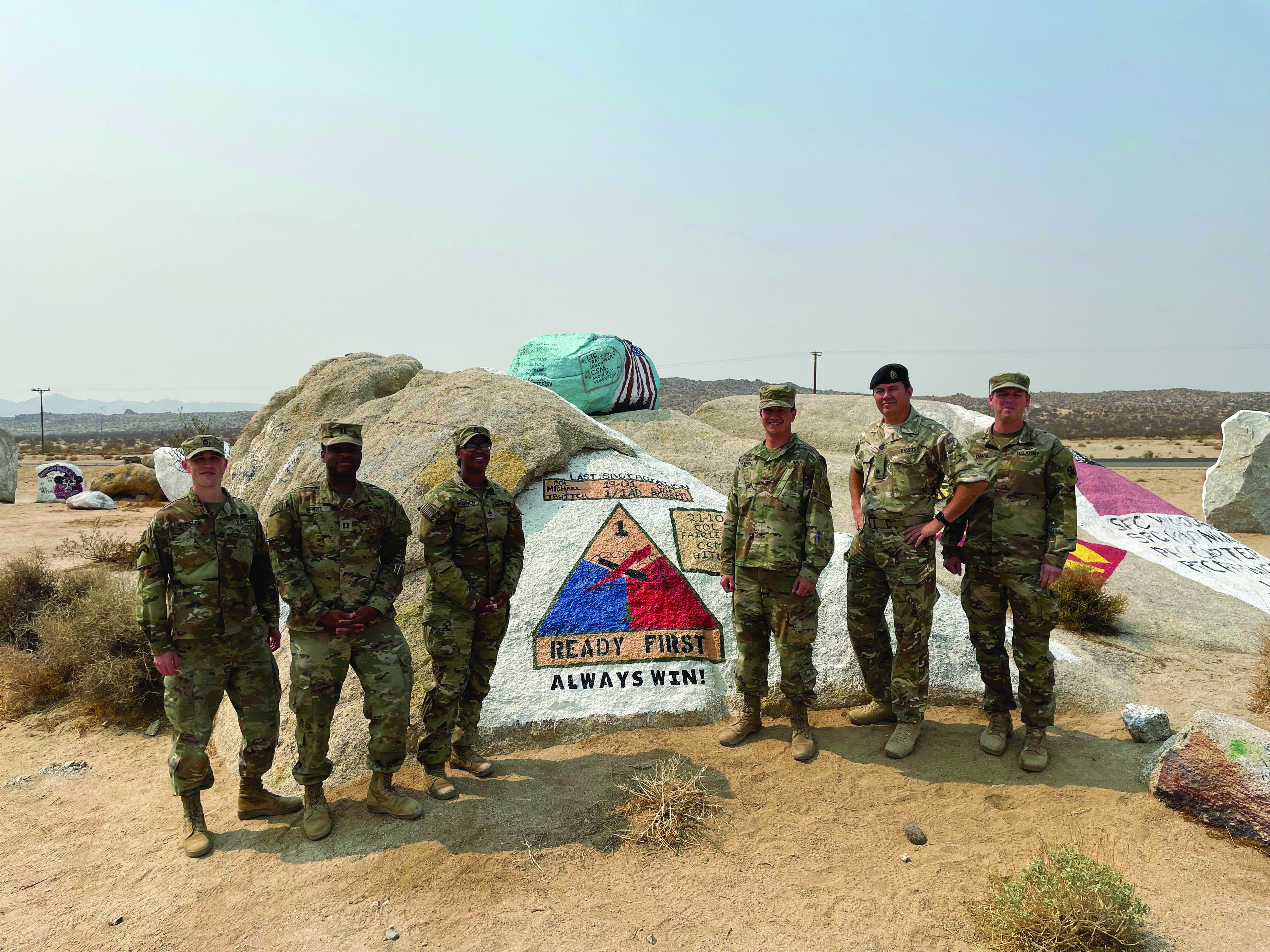 The 1st Armored Brigade Combat Team, 1st Armored Division, brigade legal section successfully completed National Training Center Rotation 21-10 and celebrated with a group photo on Painted Rocks. Pictured: SFC Shane Wheeler (OC/T), CPT Christian Hewitt (NSL JA), SSG Jasmine Warren (16 BEB Paralegal NCO), MAJ Carlos Ramirez-Vazquez (BJA), Maj (UK) Jon Harris (UK Legal Exchange Officer), and MAJ Tim Davis (Sr. Legal OC/T). Not pictured: SSG Naphese Govan (Acting NCOIC), SGT Sebastian Van Rooyen (6-1 Cav Paralegal NCO), and SGT Michlo Bocanegra (4-70 AR Paralegal NCO). 